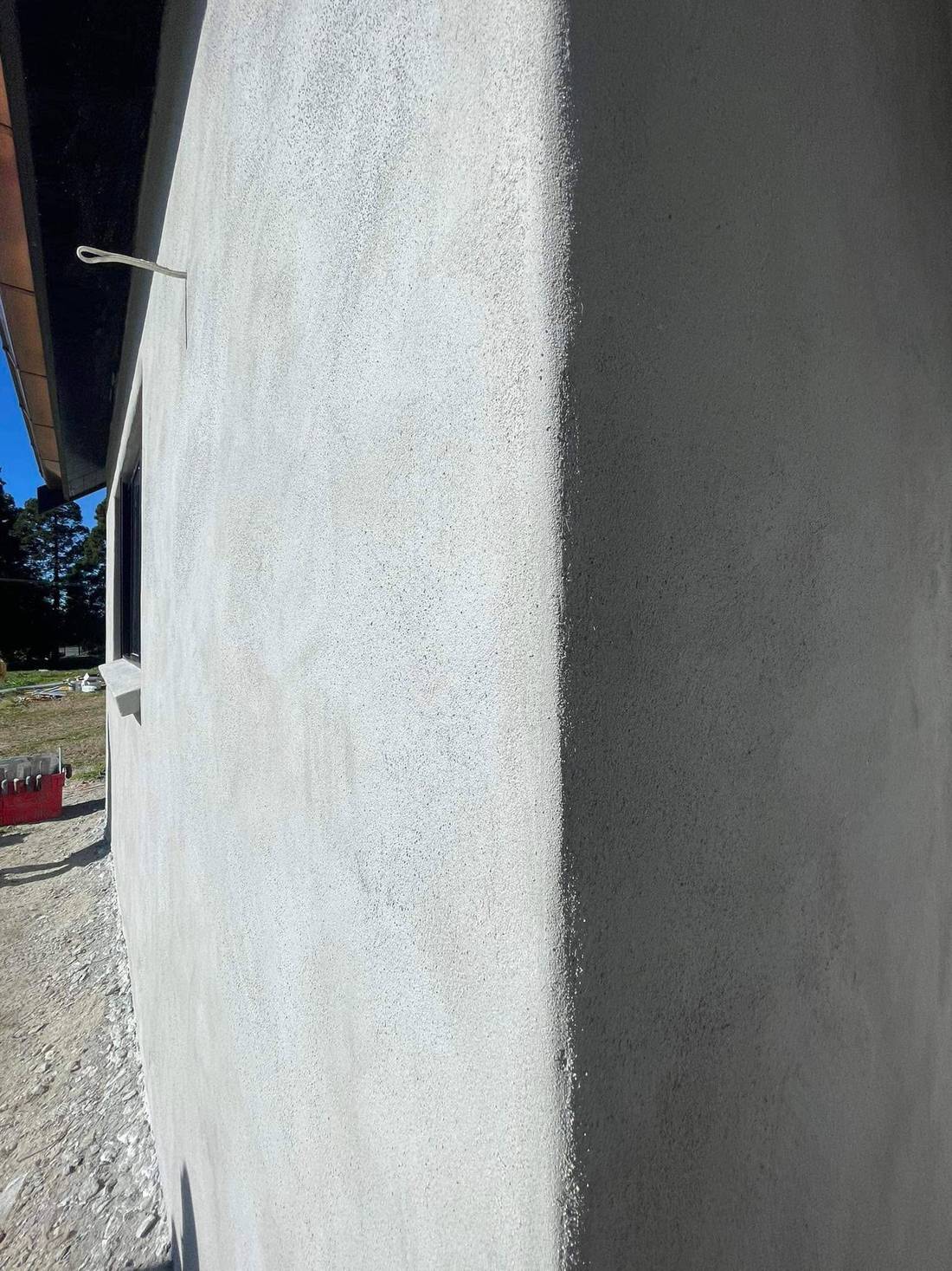 Detail of a plastered exterior elevation showing texture consistency around window junctions
